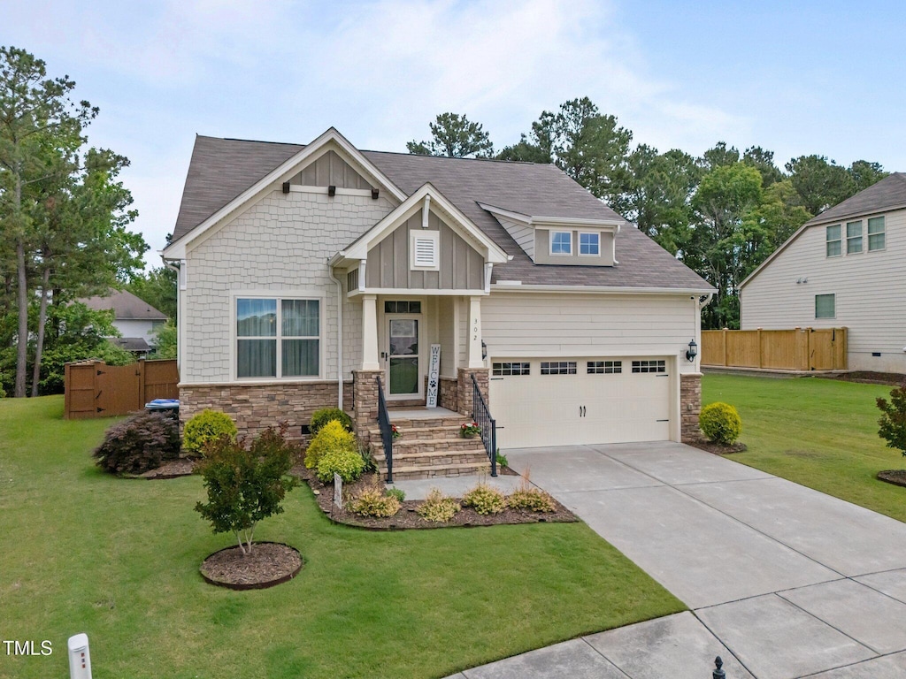 302 Kinney Glenn Ct, Durham, NC 27713 - craftsman house featuring stone siding, concrete driveway, and board and batten siding