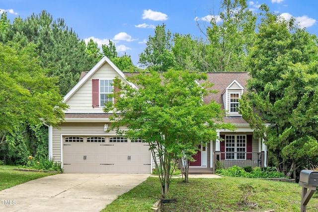 view of front of property featuring an attached garage, concrete driveway, and a porch