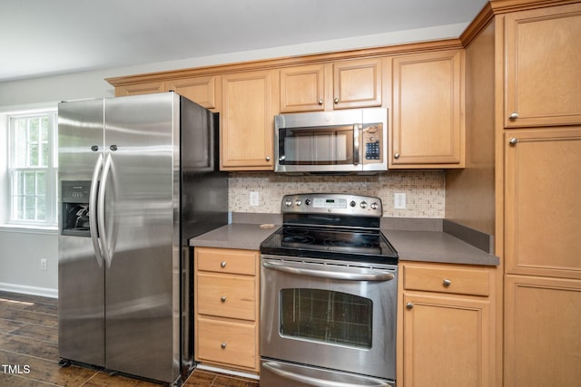 kitchen with stainless steel appliances, dark countertops, decorative backsplash, dark wood-type flooring, and baseboards