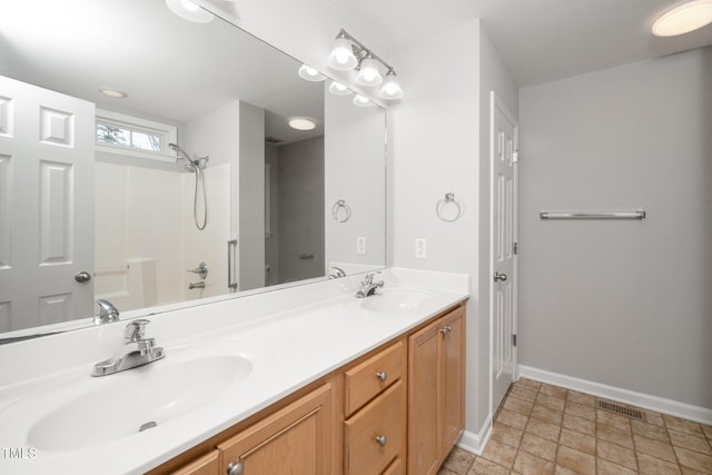 bathroom with baseboards and double vanity