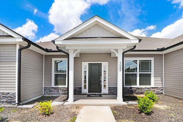 5082 Dogwood Dr, Battleboro, NC 27809 - doorway to property featuring stone siding, covered porch, and a shingled roof