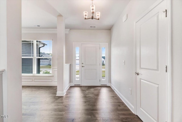 5082 Dogwood Dr, Battleboro, NC 27809 - entrance foyer featuring dark wood-style floors, a chandelier, ornamental molding, and baseboards