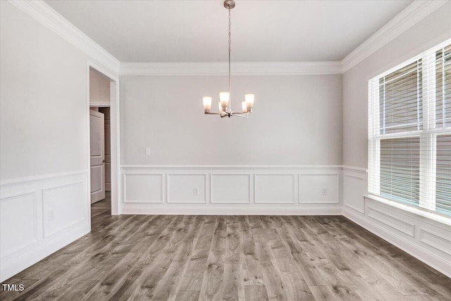 5082 Dogwood Dr, Battleboro, NC 27809 - unfurnished dining area with a chandelier, ornamental molding, healthy amount of natural light, a decorative wall, and wainscoting