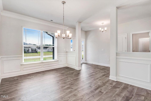 5082 Dogwood Dr, Battleboro, NC 27809 - unfurnished dining area with a chandelier, wood finished floors, a wainscoted wall, a decorative wall, and crown molding