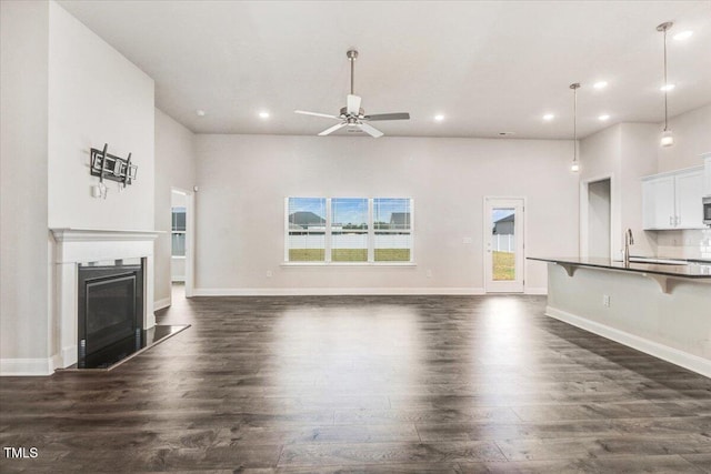 5082 Dogwood Dr, Battleboro, NC 27809 - unfurnished living room featuring dark wood-style floors, recessed lighting, a ceiling fan, a glass covered fireplace, and baseboards