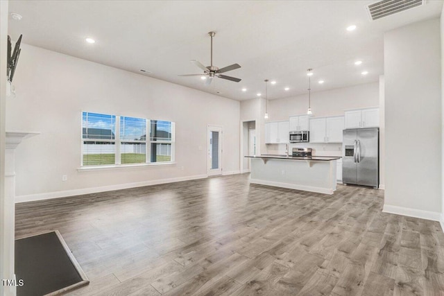 5082 Dogwood Dr, Battleboro, NC 27809 - kitchen featuring stainless steel appliances, open floor plan, a ceiling fan, white cabinetry, and recessed lighting