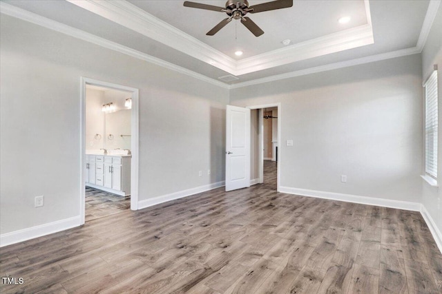 5082 Dogwood Dr, Battleboro, NC 27809 - unfurnished bedroom with ornamental molding, wood finished floors, a tray ceiling, baseboards, and ensuite bath