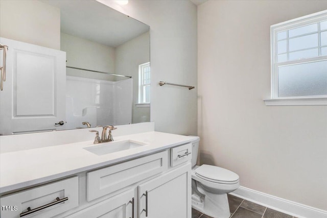 5082 Dogwood Dr, Battleboro, NC 27809 - bathroom featuring a shower, toilet, vanity, baseboards, and tile patterned flooring