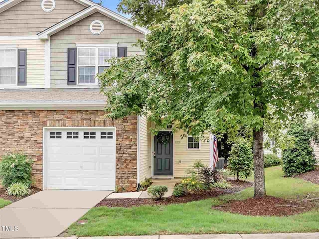 8219 Martello Ln, Raleigh, NC 27613 - view of front of house featuring concrete driveway, stone siding, and an attached garage