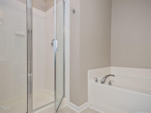 8219 Martello Ln, Raleigh, NC 27613 - bathroom featuring a garden tub, baseboards, and a stall shower