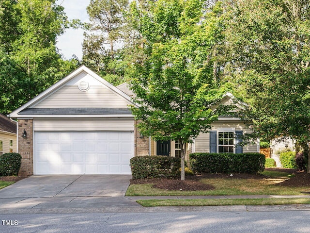 view of front facade with driveway, an attached garage, and brick siding