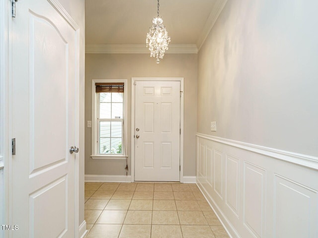 foyer featuring a chandelier, crown molding, and light tile patterned flooring