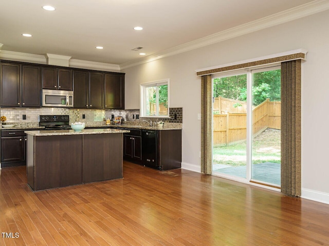 kitchen featuring black appliances, ornamental molding, decorative backsplash, dark wood-style flooring, and dark brown cabinets