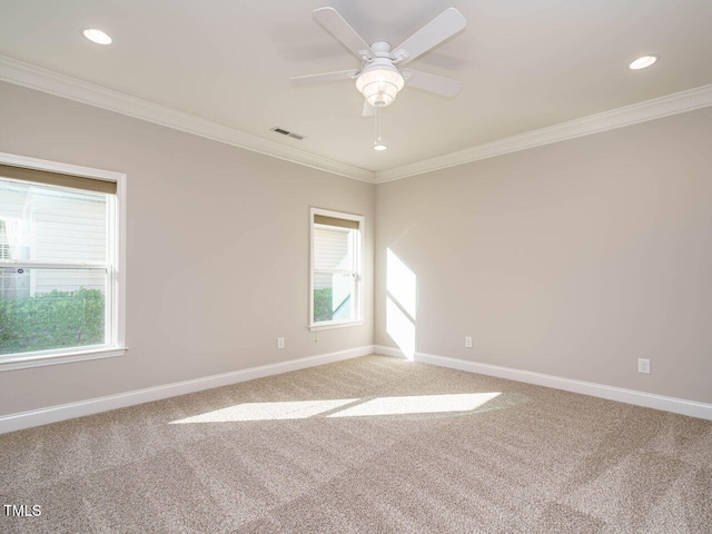 carpeted spare room featuring crown molding, baseboards, a ceiling fan, and recessed lighting