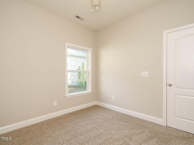 empty room featuring carpet floors, baseboards, and ceiling fan