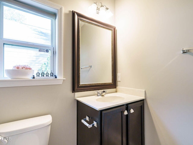 bathroom with toilet and vanity