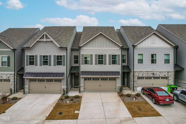 view of property with stone siding, board and batten siding, driveway, and an attached garage