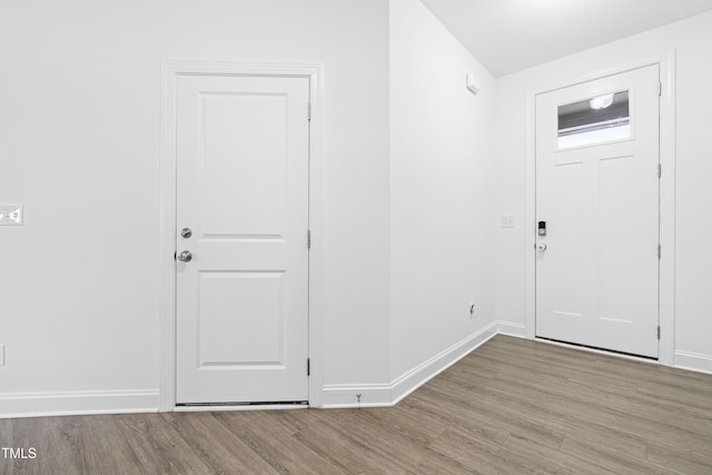 entrance foyer with baseboards and wood finished floors