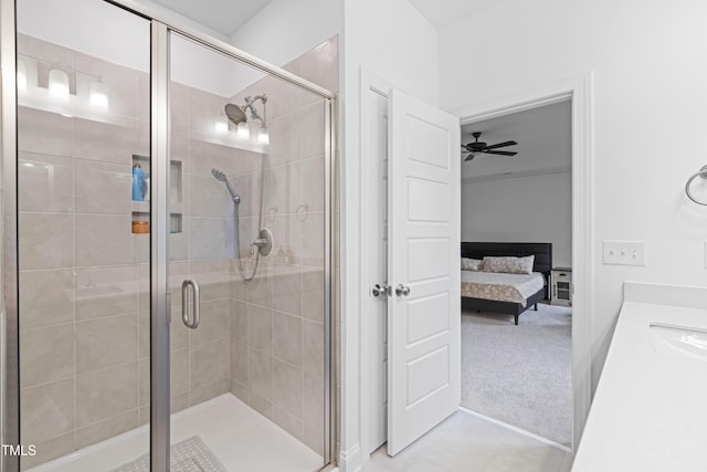 bathroom with a shower stall, connected bathroom, ceiling fan, and vanity