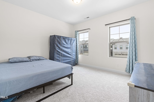 bedroom featuring visible vents, baseboards, and carpet floors