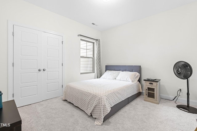 bedroom featuring carpet flooring, a closet, visible vents, and baseboards