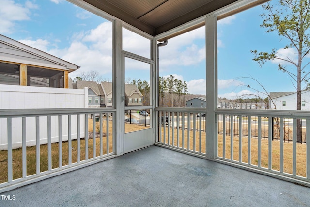 unfurnished sunroom featuring a residential view