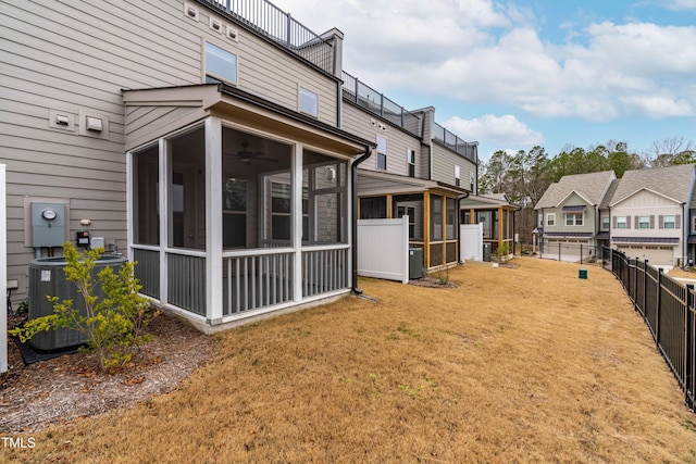 view of yard with a sunroom, a residential view, a fenced backyard, and central AC