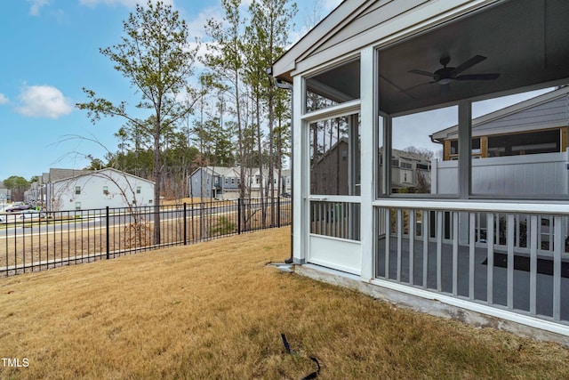 view of yard featuring a residential view, a sunroom, and a fenced backyard