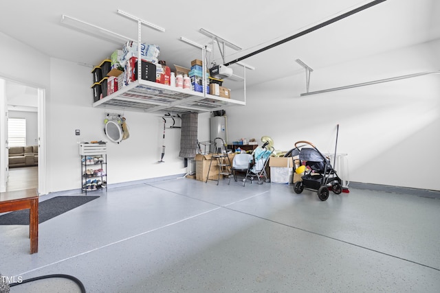 garage with water heater and a garage door opener