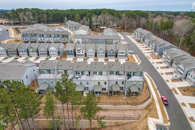 aerial view featuring a forest view and a residential view