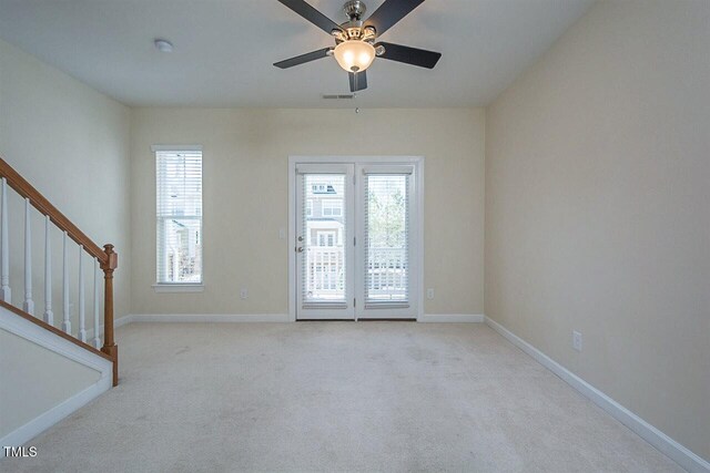 8016 Sycamore Hill Ln, Raleigh, NC 27612 - carpeted empty room featuring visible vents, baseboards, a ceiling fan, and stairs