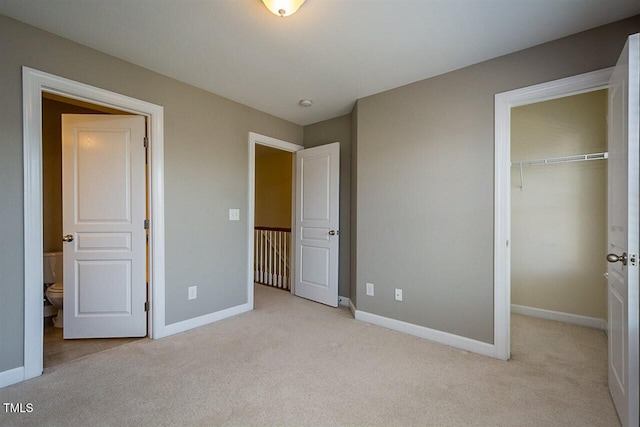 8016 Sycamore Hill Ln, Raleigh, NC 27612 - unfurnished bedroom featuring baseboards, carpet flooring, a closet, and a spacious closet
