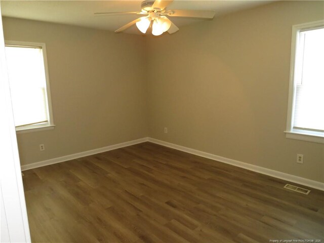 6324 Brussels Ct, Fayetteville, NC 28304 - unfurnished room featuring dark wood-style flooring, baseboards, a ceiling fan, and visible vents