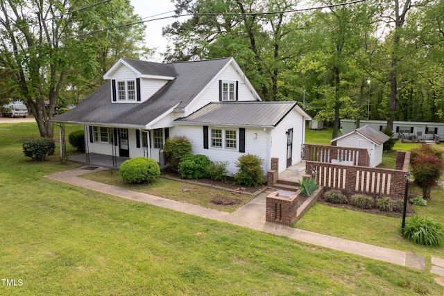 183 Red Hill Loop Rd, Warrenton, NC 27589 - cape cod home with covered porch, a garage, an outdoor structure, and a front yard