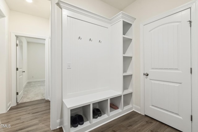 mudroom featuring dark wood-style flooring and baseboards