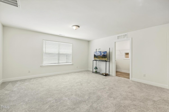 unfurnished living room featuring carpet floors and baseboards