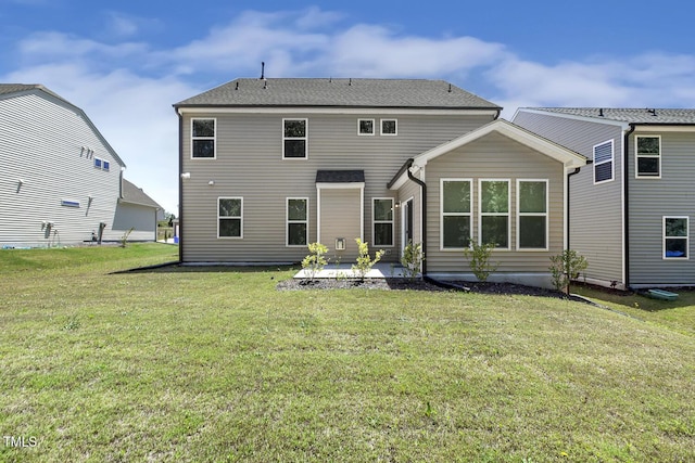 rear view of property with a patio area and a yard