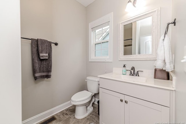 bathroom featuring toilet, marble finish floor, vanity, visible vents, and baseboards