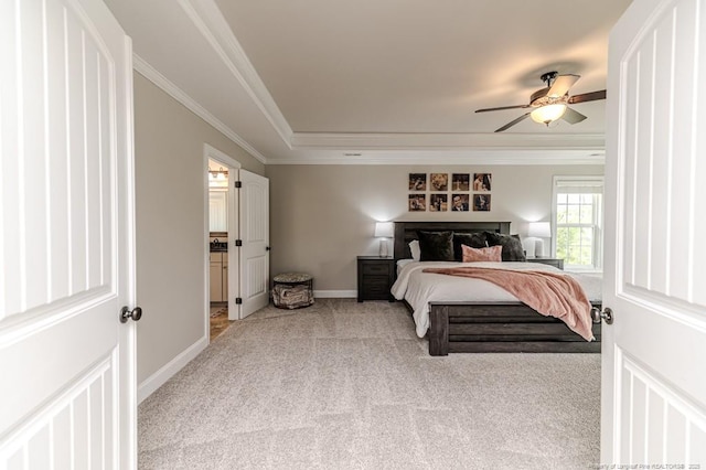 bedroom featuring carpet flooring, baseboards, a raised ceiling, ceiling fan, and ornamental molding
