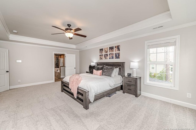 carpeted bedroom with visible vents, baseboards, a raised ceiling, and ornamental molding
