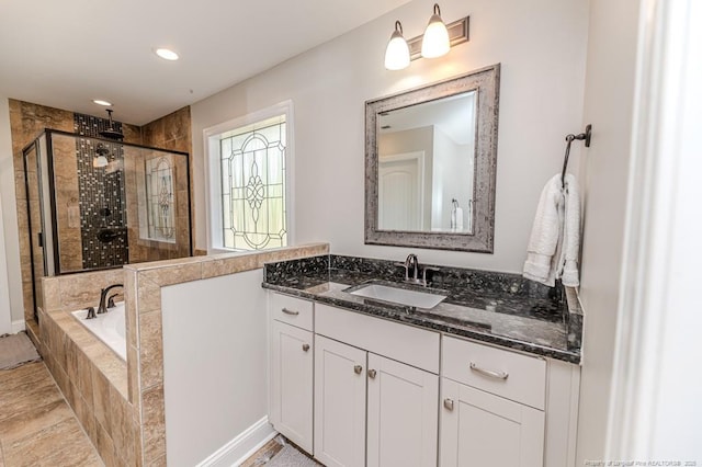 full bath featuring a stall shower, vanity, recessed lighting, and a bath