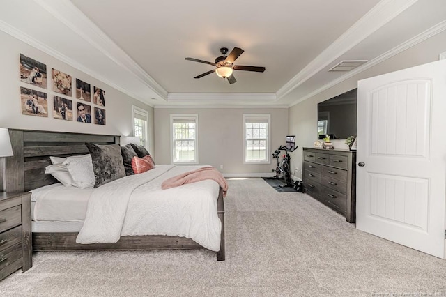 carpeted bedroom with ceiling fan, visible vents, a raised ceiling, and ornamental molding