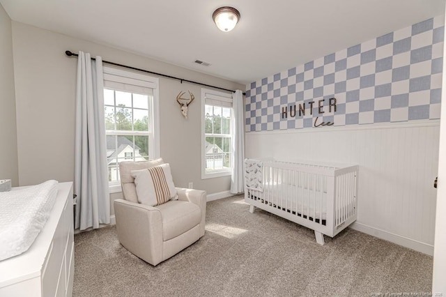 bedroom featuring wallpapered walls, light carpet, and baseboards
