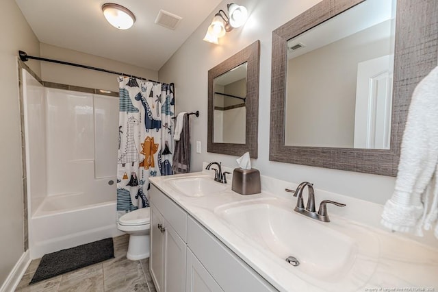 bathroom with toilet, visible vents, a sink, and double vanity