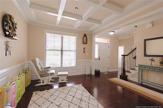 interior space with coffered ceiling, beam ceiling, dark wood finished floors, wainscoting, and stairs