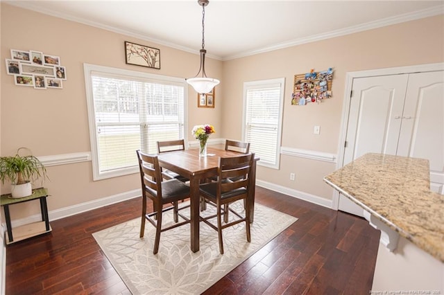 dining area with crown molding, dark wood-style flooring, and baseboards