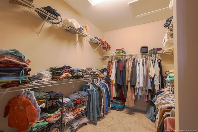 spacious closet with attic access and carpet floors