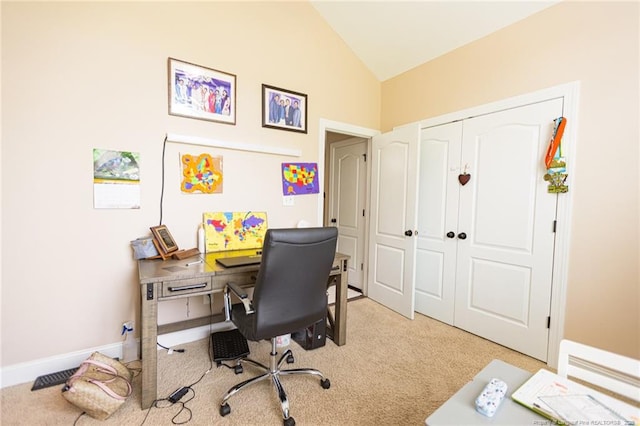 office space with light colored carpet and vaulted ceiling