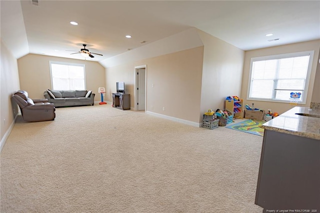 playroom featuring carpet flooring, baseboards, lofted ceiling, and a ceiling fan
