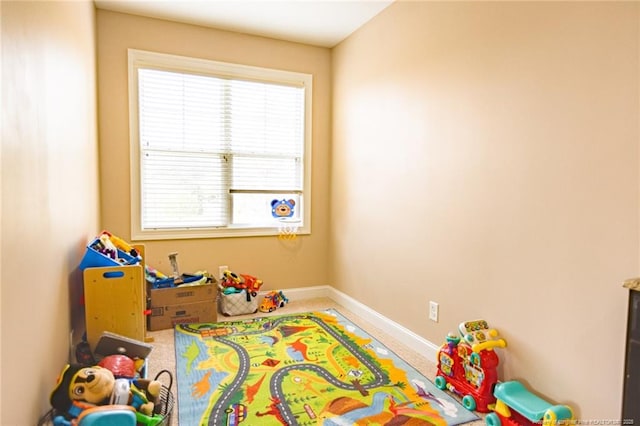 rec room featuring carpet and baseboards